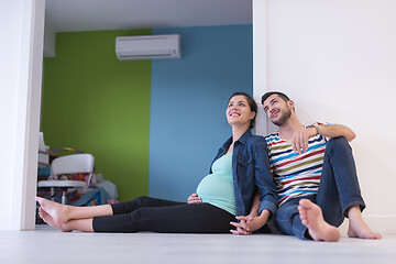Image showing pregnant couple sitting on the floor