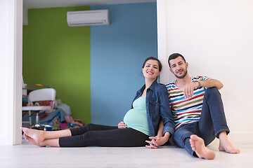 Image showing pregnant couple sitting on the floor