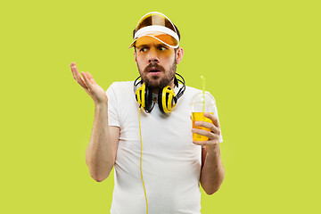 Image showing Half-length close up portrait of young man on yellow background