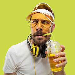 Image showing Half-length close up portrait of young man on yellow background