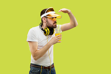 Image showing Half-length close up portrait of young man on yellow background