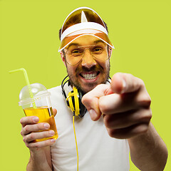 Image showing Half-length close up portrait of young man on yellow background