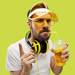 Image showing Half-length close up portrait of young man on yellow background