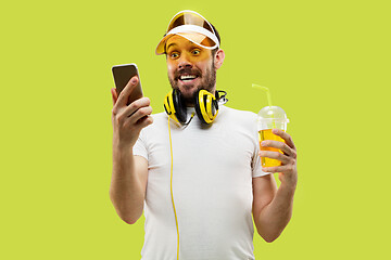 Image showing Half-length close up portrait of young man on yellow background