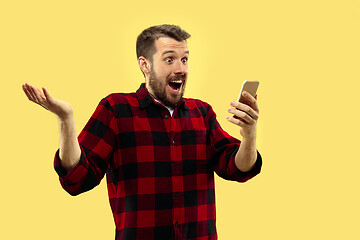 Image showing Half-length close up portrait of young man on yellow background.