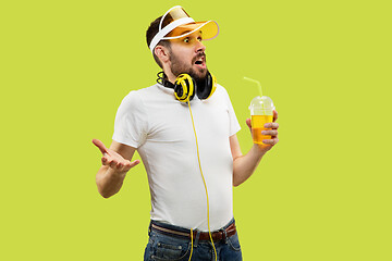 Image showing Half-length close up portrait of young man on yellow background