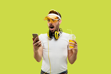 Image showing Half-length close up portrait of young man on yellow background