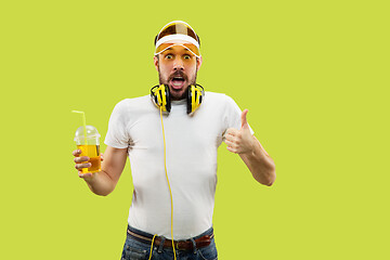 Image showing Half-length close up portrait of young man on yellow background