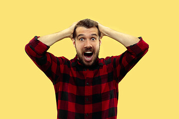 Image showing Half-length close up portrait of young man on yellow background.