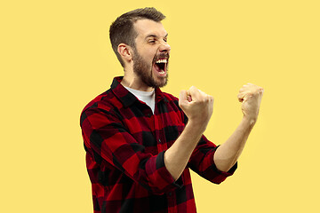 Image showing Half-length close up portrait of young man on yellow background.