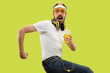 Image showing Half-length close up portrait of young man on yellow background