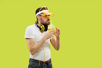 Image showing Half-length close up portrait of young man on yellow background