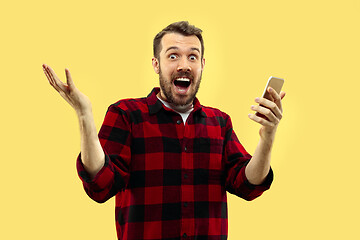 Image showing Half-length close up portrait of young man on yellow background.