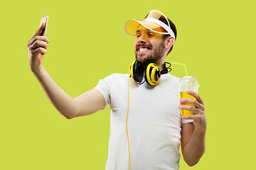 Image showing Half-length close up portrait of young man on yellow background