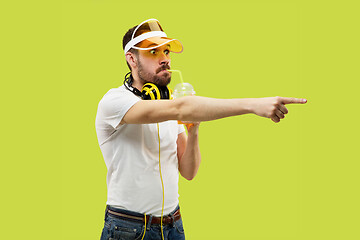 Image showing Half-length close up portrait of young man on yellow background