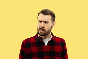 Image showing Half-length close up portrait of young man on yellow background.