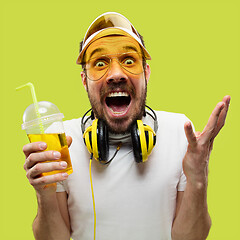 Image showing Half-length close up portrait of young man on yellow background