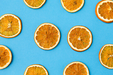 Image showing dried orange slices on blue background