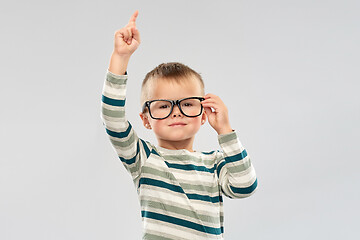 Image showing portrait of boy in glasses pointing finger up