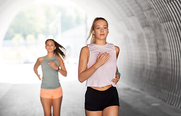 Image showing young women or female friends running outdoors