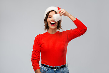 Image showing happy young woman in santa hat on christmas