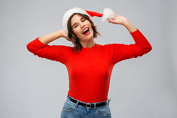 Image showing happy young woman in santa hat on christmas