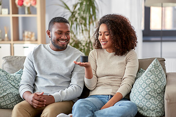 Image showing african american couple with smart speaker at home