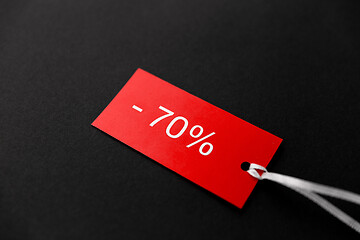 Image showing red tags with discount signs on black background