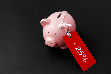 Image showing piggy bank with red sale tag on black