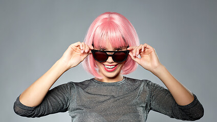 Image showing happy woman in pink wig and black sunglasses