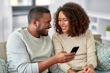 Image showing african american couple with smartphone at home