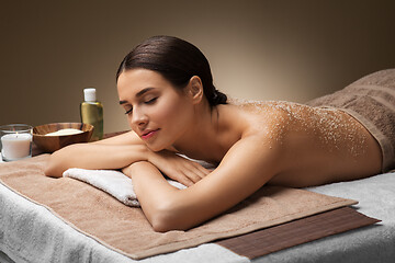 Image showing woman lying with sea salt on skin at spa