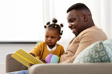 Image showing african father reading book for baby daughter