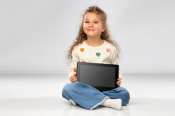 Image showing smiling girl with tablet computer sitting on floor