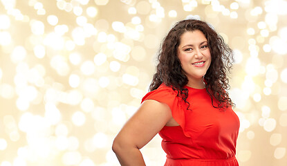 Image showing happy woman in red dress over lights background