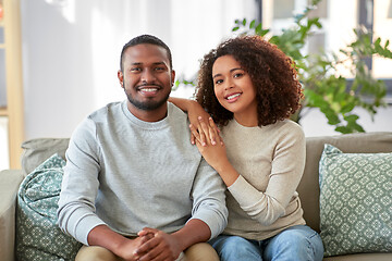 Image showing happy african american couple on sofa at home