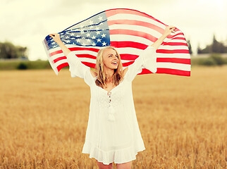 Image showing happy woman with american flag on cereal field