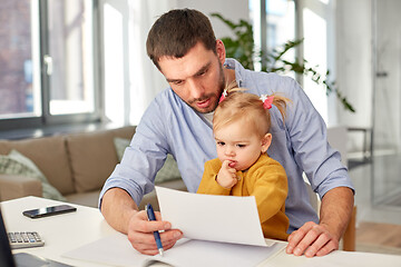 Image showing working father with baby daughter at home office