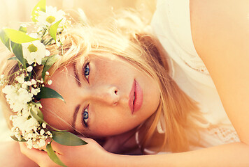 Image showing happy woman in wreath of flowers on cereal field