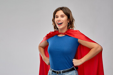 Image showing happy woman in red superhero cape