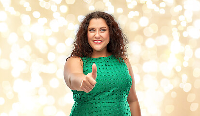 Image showing happy woman showing thumbs up over lights