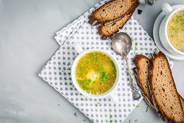 Image showing Homemade egg soup with fresh sourdough bread