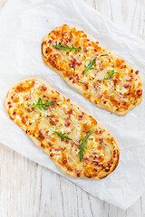 Image showing Tarte Flambee - flat bread (Flammkuchen) with bacon, onion, champignon and cheese