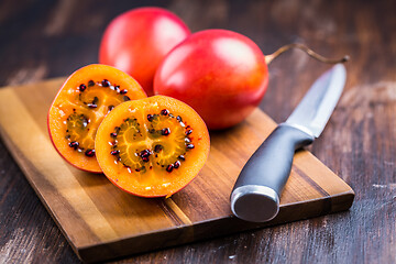 Image showing Organic tamarillo (tree tomato) on cutting board