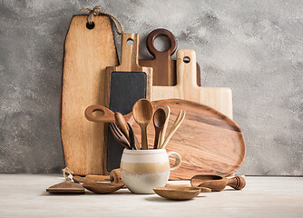 Image showing Assortment of wooden cutting boards and kitchen utensils