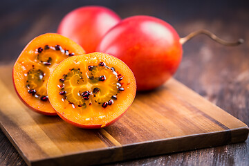 Image showing Organic tamarillo (tree tomato) on cutting board