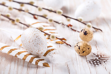 Image showing Easter eggs with feathers and pussy willow branch. Easter decoration