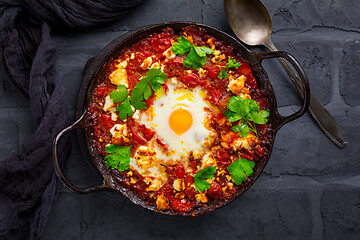 Image showing Shakshuka -  dish of eggs poached in a tomato sauce with Feta cheese and coriander