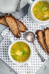 Image showing Homemade egg soup with fresh sourdough bread