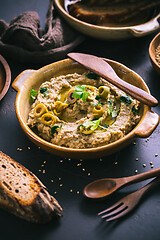 Image showing Arabic Aubergine paste or dip Baba Ghanoush with olives and sesame seeds